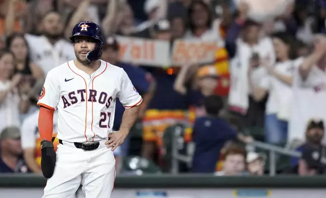 Houston Astros' Jose Altuve stands on third base while waiting on a review of his solo home run against the Baltimore Orioles during the seventh inning of a baseball game, Saturday, Aug. 16, 2025, in Houston. (AP Photo/Eric Christian Smith)