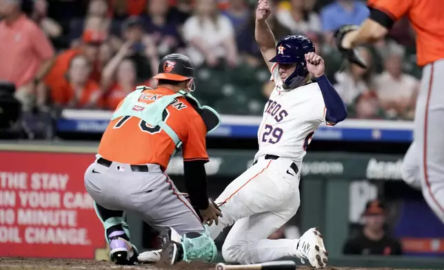 Houston Astros' Ramon Urias (29) is tagged out by catcher Alex Jackson, left, during the eleventh inning of a baseball game, Saturday, Aug. 16, 2025, in Houston. (AP Photo/Eric Christian Smith)