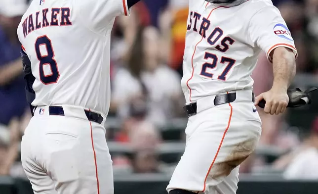 Houston Astros' Jose Altuve (27) celebrates his solo home run against the Baltimore Orioles with Christian Walker during the seventh inning of a baseball game, Saturday, Aug. 16, 2025, in Houston. (AP Photo/Eric Christian Smith)