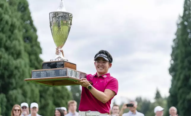 Akie Iwai, of Japan, holds up the trophy after winning the LPGA Portland Classic golf tournament at Columbia Edgewater in Portland, Ore., Sunday, Aug. 17, 2025. (AP Photo/Ali Gradischer)