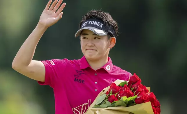 Akie Iwai, of Japan, waves towards the crowd after winning the LPGA Portland Classic golf tournament at Columbia Edgewater in Portland, Ore., Sunday, Aug. 17, 2025. (AP Photo/Ali Gradischer)