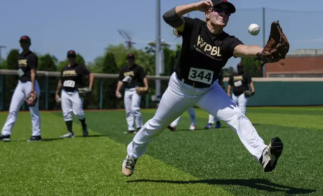 Nikki Hesson reaches towards the ball during the first day of tryouts for the Women's Professional Baseball League, Friday, Aug 22, 2025, at the Washington Nationals Youth Baseball Academy in Washington. (AP Photo/Julia Demaree Nikhinson)