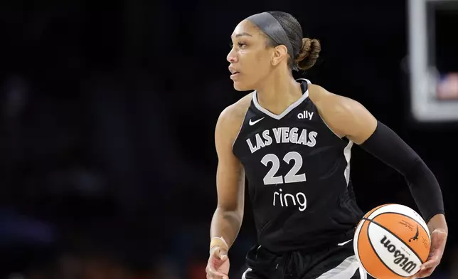 Las Vegas Aces center A'ja Wilson controls the ball during the second half of a WNBA basketball game against the Connecticut Sun, Sunday, Aug. 10, 2025, in Las Vegas. (Steve Marcus/Las Vegas Sun via AP)