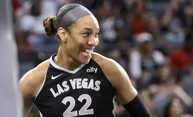 Las Vegas Aces center A'ja Wilson reacts after making a basket and drawing a foul during the second half of a WNBA basketball game against the Connecticut Sun, Sunday, Aug. 10, 2025, in Las Vegas. (Steve Marcus/Las Vegas Sun via AP)