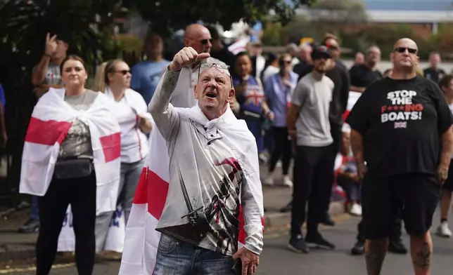 People demonstrating under the Abolish Asylum System slogan outside the Castle Bromwich Holiday Inn in Birmingham, England, Sunday, Aug. 24, 2025. (Jacob King/PA via AP)