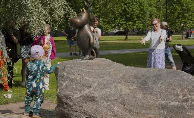 Finland Moomins Fans celebrate the 80th anniversary of the publication of the Finnish children's classic, "The Moomins and The Great Flood," and the birthday of the author Tove Jansson, in Tampere, Finland, Saturday, Aug. 9, 2025. (AP Photo/Tommi Ojala)