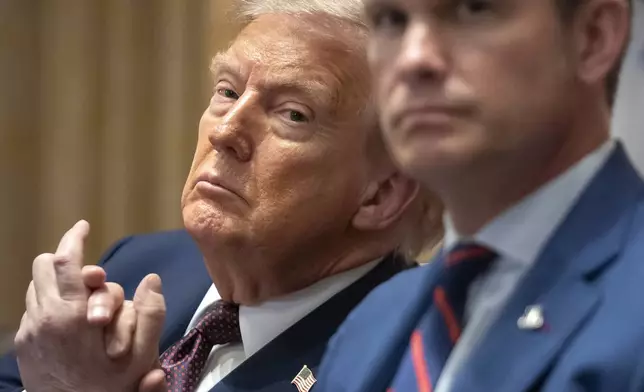 President Donald Trump, left, and Defense Secretary Pete Hegseth listen during a cabinet meeting at the White House, Tuesday, Aug. 26, 2025, in Washington. (AP Photo/Mark Schiefelbein)