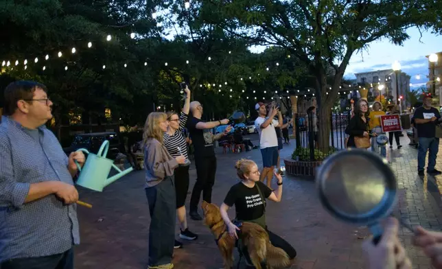 People hold a grassroots, daily, five-minute pots and pans protest to demonstrate against President Donald Trump's immigration policies, in the Mt. Pleasant neighborhood of Washington, Tuesday, Aug. 26, 2025. (AP Photo/Rod Lamkey, Jr.)