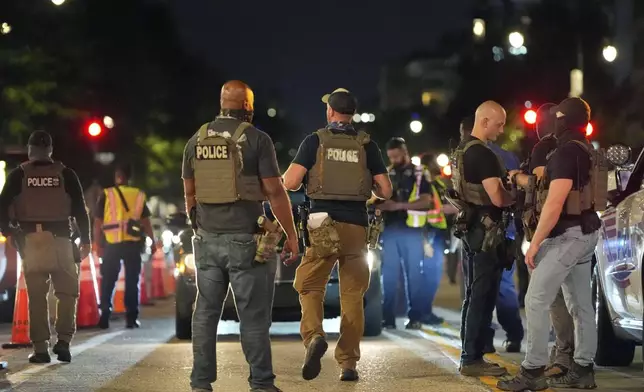 Department of Homeland Security Investigations agents join Washington Metropolitan Police Department officers as they conduct traffic checks at a checkpoint along 14th Street in northwest Washington, Wednesday, Aug. 13, 2025, in Washington. (AP Photo/Alex Brandon)