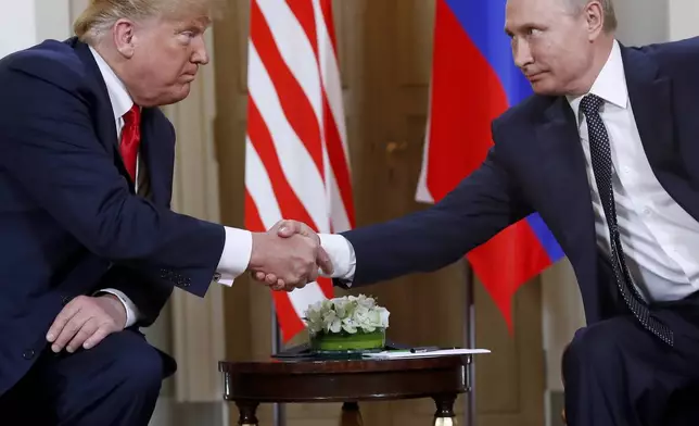 FILE - President Donald Trump, left, and Russian President Vladimir Putin shake hands at the beginning of a meeting at the Presidential Palace in Helsinki, Finland, July 16, 2018. (AP Photo/Pablo Martinez Monsivais, File)