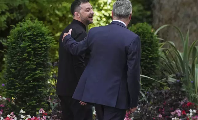 Britain's Prime Minister Keir Starmer, right, walks out with Ukraine's President Volodymyr Zelenskyy after a meeting at Downing Street in London, Thursday, Aug. 14, 2025. (AP Photo/Kirsty Wigglesworth)