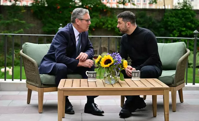 Britain's Prime Minister Keir Starmer, left, talks with Ukraine's President Volodymyr Zelenskyy in the garden of 10 Downing Street in London, Thursday Aug. 14, 2025. (Ben Stansall/Pool Photo via AP)