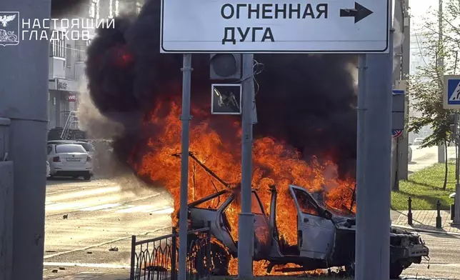 In this photo, released by Belgorod regional governor Vyacheslav Gladkov's Telegram channel on Thursday, Aug. 14, 2025, flames rise from a burning car in a street after a drone attack by the Armed Forces of Ukraine on the city of Belgorod. (Belgorod Region Governor Vyacheslav Gladkov Telegram channel via AP)