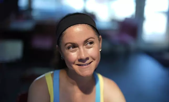 Lorie Stefaneli, a New York City based consultant who flies to Tuscaloosa each year for sorority rush, poses for a photo near the University of Alabama, Thursday, Aug. 14, 2025, in Tuscaloosa, Ala. (AP Photo/Brynn Anderson)