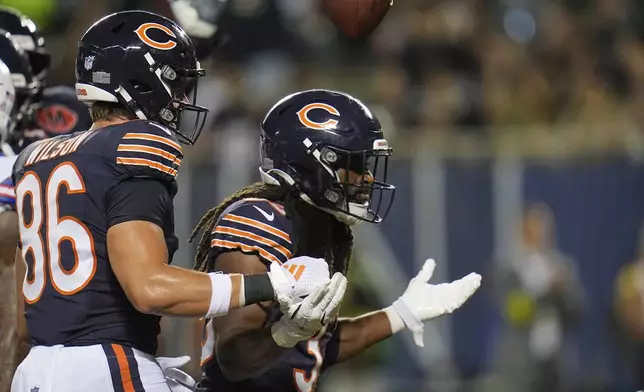 Chicago Bears running back Ian Wheeler, right, celebrates with Joel Wilson (86) after Wheeler rushed for a touchdown in the first half of a preseason NFL football game against the Buffalo Bills Sunday, Aug. 17, 2025, in Chicago. (AP Photo/Erin Hooley)