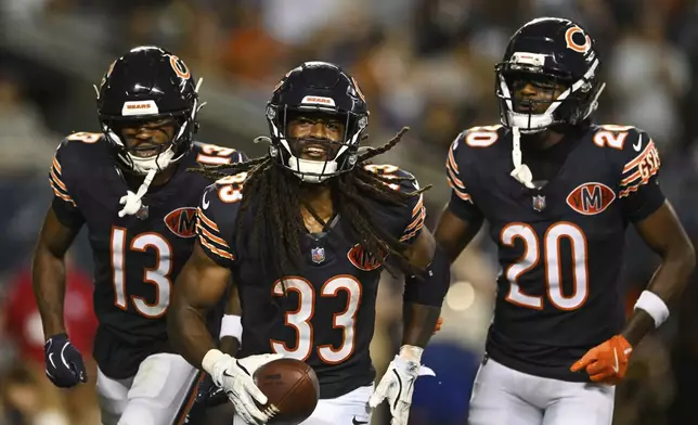 Chicago Bears running back Ian Wheeler (33), Maurice Alexander (13) and Jahdae Walker (20) celebrate after Wheeler rushed for a touchdown in the second half of a preseason NFL football game against the Buffalo Bills Sunday, Aug. 17, 2025, in Chicago. (AP Photo/Paul Beaty)