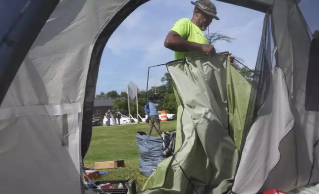 George M., who has been living at a tent encampment, packs up his tent, Thursday, Aug. 14, 2025 in Washington. (AP Photo/Jacquelyn Martin)