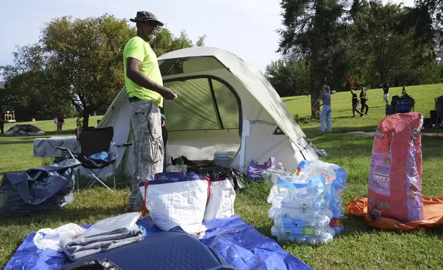 George M., who has been living at a tent encampment, packs up before a 10 a.m. deadline, Thursday, Aug. 14, 2025 in Washington. (AP Photo/Jacquelyn Martin)