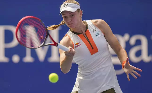Elena Rybakina, of Kazakhstan, returns a shot to Emma Raducanu, of Great Britain, during the third round of the U.S. Open tennis championships, Friday, Aug. 29, 2025, in New York. (AP Photo/Kirsty Wigglesworth)