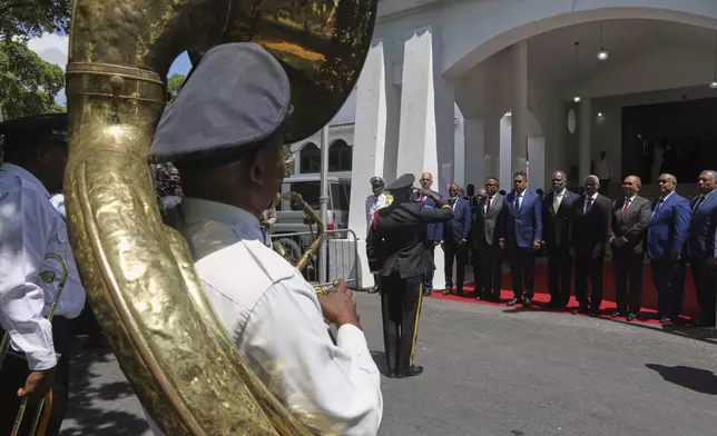 Transitional presidential council members listen to Haiti's national anthem during the installation ceremony of Laurent Saint-Cyr as the new president of the council in Port-au-Prince, Haiti, Thursday, Aug. 7, 2025. (AP Photo/Odelyn Joseph)