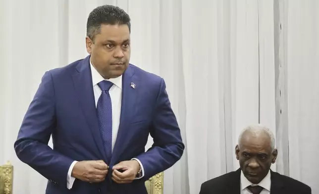 Laurent Saint-Cyr, left, attends the ceremony for his appointment as president of the Transitional Council in Port-au-Prince, Haiti, Thursday, Aug. 7, 2025. (AP Photo/Odelyn Joseph)