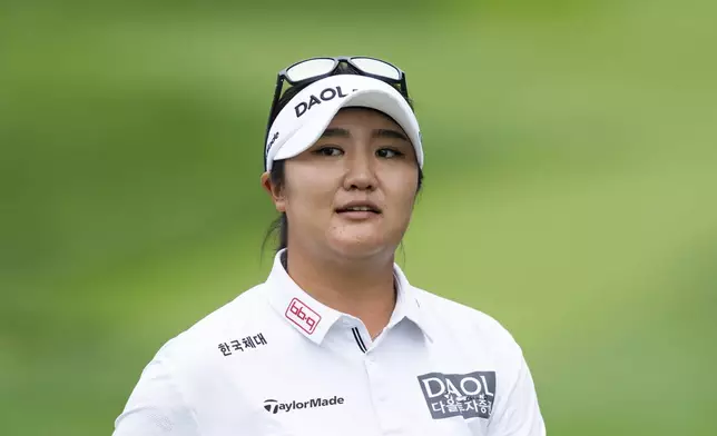 Haeran Ryu, of South Korea, looks towards the crowd after hitting off the first tee during the first round of the LPGA Portland Classic golf tournament at Columbia Edgewater in Portland, Ore., Thursday, Aug. 14, 2025. (AP Photo/Ali Gradischer)