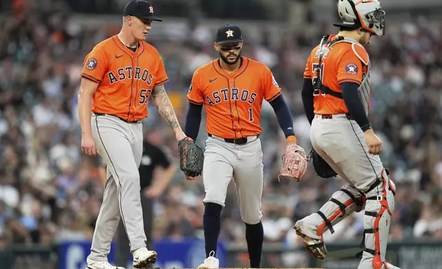 Houston Astros starting pitcher Hunter Brown, left, meets with third baseman Carlos Correa, center, and catcher Yainier Diaz for a mound visit during the third inning of a baseball game, Tuesday, Aug. 19, 2025, in Detroit. (AP Photo/Ryan Sun)