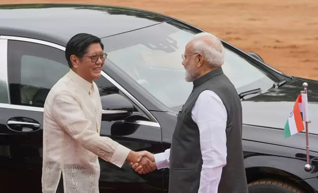 Indian Prime Minister Narendra Modi, right welcomes visiting Philippines President Ferdinand Marcos Jr. upon on arrival at the Indian presidential palace in New Delhi, India, Tuesday, Aug. 5, 2025. (AP Photo/Manish Swarup)