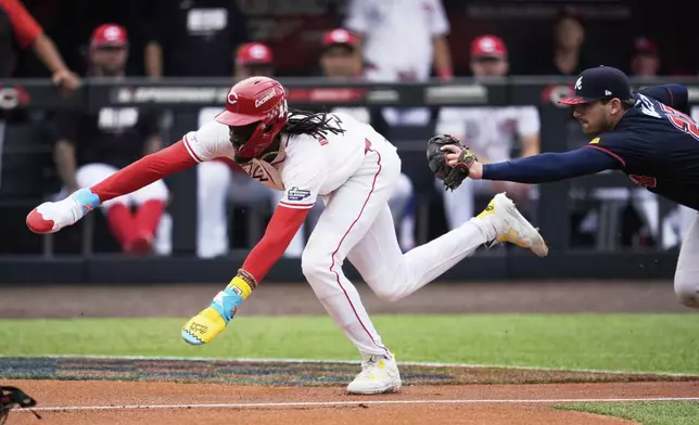 Cincinnati Reds' Elly De La Cruz is tagged out by Atlanta Braves third base Austin Riley during the first inning of the MLB Speedway Classic baseball game at Bristol Motor Speedway in Bristol, Tenn., Sunday, Aug. 3, 2025. Play was resumed today after yesterday's weather delay. (AP Photo/George Walker IV)