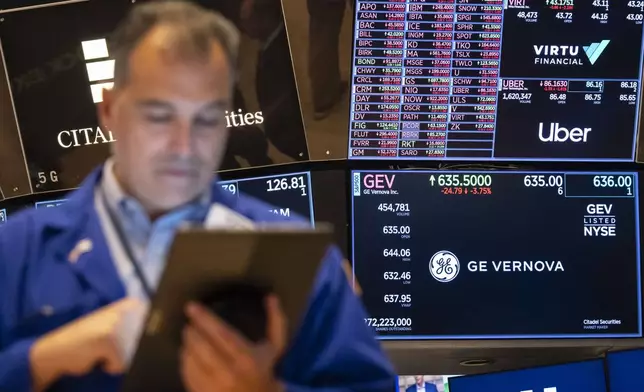 A screen shows stock prices on the floor of the New York Stock Exchange, Friday, Aug. 1, 2025, in New York. (AP Photo/Yuki Iwamura)