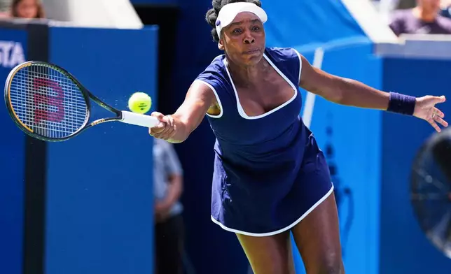 Venus Williams returns a shot during the mixed doubles competition of the U.S. Open tennis tournament in New York, Tuesday, Aug. 19, 2025. (AP Photo/Yuki Iwamura)