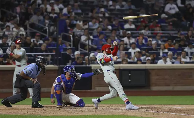Philadelphia Phillies' Bryce Harper loses grip on his bat during the seventh inning of a baseball game against the New York Mets, Wednesday, Aug. 27, 2025, in New York. (AP Photo/Pamela Smith)