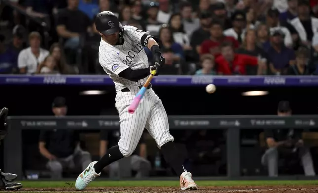 Colorado Rockies' Tyler Freeman (2) hits a two-run home run in the eighth inning of a baseball game against the Arizona Diamondbacks Saturday, Aug. 16, 2025, in Denver. (AP Photo/Geneva Heffernan)