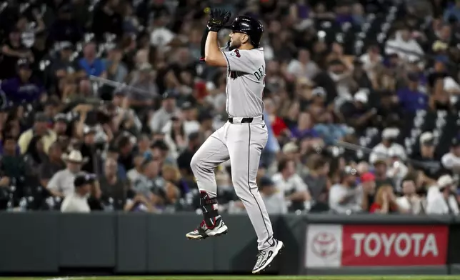 Arizona Diamondbacks' Adrian Del Castillo celebrates after hitting a two-run home run in the seventh inning of a baseball game against the Colorado Rockies, Saturday, Aug. 16, 2025, in Denver. (AP Photo/Geneva Heffernan)