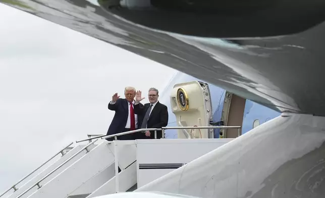 U.S. President Donald Trump, left, and Britain's Prime Minister Keir Starmer wave before boarding Air Force One at Prestwick Airport in Ayrshire, Scotland, July 28, 2025. (AP Photo/Jacquelyn Martin)