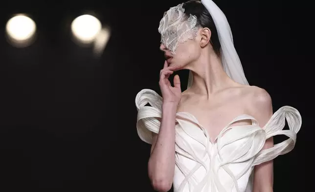 A model wears a creation from the Iris van Herpen Fall-Winter 2025/26 Haute Couture collection in Paris, July 7, 2025. (AP Photo/Tom Nicholson)