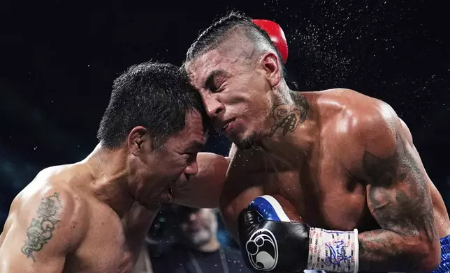 Manny Pacquiao, left, fights Mario Barrios in a welterweight title boxing match in Las Vegas, July 19, 2025. (AP Photo/John Locher)