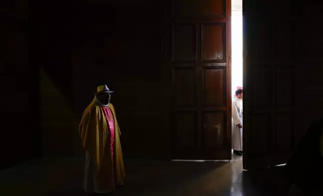 A priest attends a celebration of Chile's patron saint, Our Lady of Mount Carmel, in La Tirana, Chile, July 16, 2025. (AP Photo/Esteban Felix)