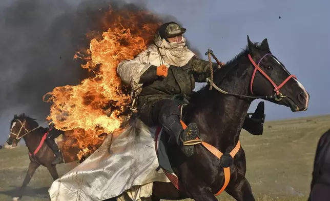 Participants of The Gallops' 2025 competition show off their skills near the alpine Song-Kol Lake in Kyrgyzstan, July 21, 2025. (AP Photo/Vladimir Voronin)