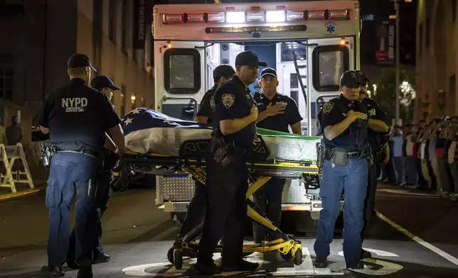 New York police bring out the body of fellow officer Didarul Islam, who was shot and killed by a gunman earlier that evening, out of NewYork-Presbyterian/Weill Cornell Medical Hospital in New York, early Tuesday, July 29, 2025. (AP Photo/Angelina Katsanis)