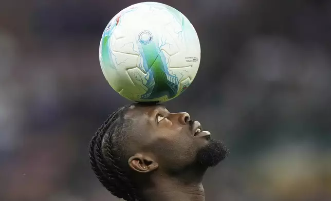 Inter Milan's Marcus Thuram controls the ball as he warms up prior to a Serie A soccer match between Inter Milan and Torino, at the San Siro stadium in Milan, Italy, Monday, Aug. 25, 2025. (AP Photo/Luca Bruno)
