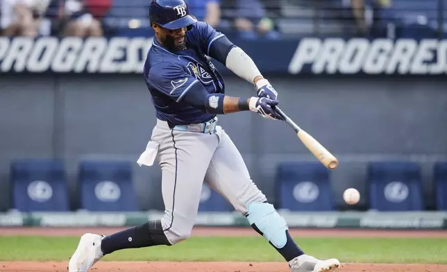 Tampa Bay Rays' Yandy Diaz hits a double in the third inning of a baseball game against the Cleveland Guardians in Cleveland, Monday, Aug. 25, 2025. (AP Photo/Sue Ogrocki)
