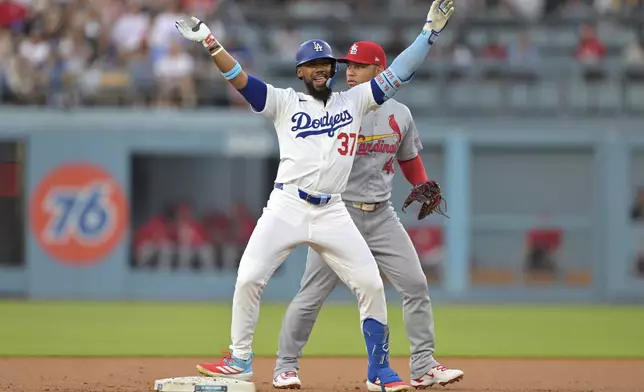 Los Angeles Dodgers' Teoscar Hernandez waves after a double during the first inning of a baseball game against the St. Louis Cardinals, Tuesday, Aug. 5, 2025, in Los Angeles. (AP Photo/Jayne Kamin-Oncea)