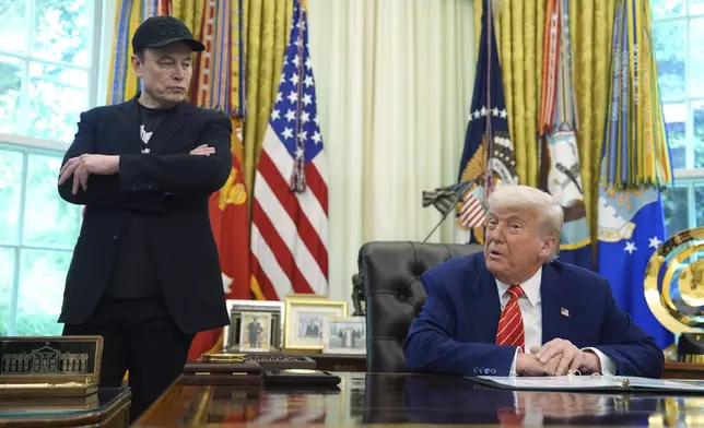 FILE - President Donald Trump, right, speaks during a news conference with Elon Musk in the Oval Office of the White House, Friday, May 30, 2025, in Washington. (AP Photo/Evan Vucci, File)