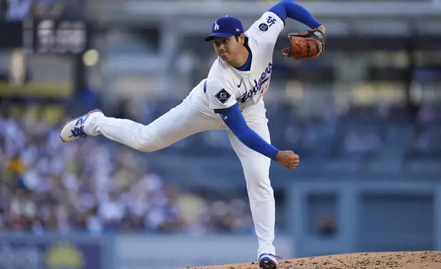 Los Angeles Dodgers starting pitcher Shohei Ohtani works against a Cincinnati Reds batter during the first inning of a baseball game Wednesday, Aug. 27, 2025, in Los Angeles. (AP Photo/Mark J. Terrill)