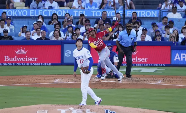 Cincinnati Reds' Noelvi Marte, right, watches his home run behind Los Angeles Dodgers starting pitcher Shohei Ohtani during the third inning of a baseball game Wednesday, Aug. 27, 2025, in Los Angeles. (AP Photo/Mark J. Terrill)