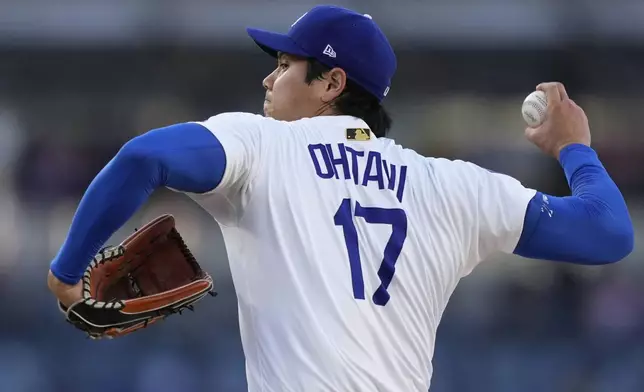 Los Angeles Dodgers starting pitcher Shohei Ohtani works against a Cincinnati Reds batter during the first inning of a baseball game Wednesday, Aug. 27, 2025, in Los Angeles. (AP Photo/Mark J. Terrill)
