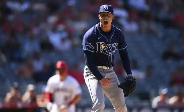Tampa Bay Rays pitcher Griffin Jax reacts after striking out three batters in a row with the bases loaded during the eighth inning of a baseball game against the Los Angeles Angels Wednesday, Aug. 6, 2025, in Anaheim, Calif. (AP Photo/William Liang)