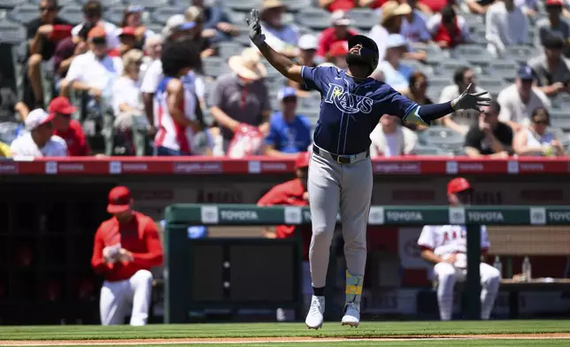 Tampa Bay Rays' Junior Caminero gestures after hitting a home run during the first inning of a baseball game against the Los Angeles Angels Wednesday, Aug. 6, 2025, in Anaheim, Calif. (AP Photo/William Liang)