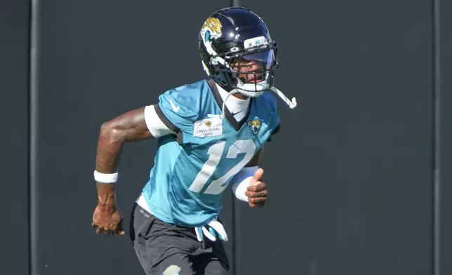 Jacksonville Jaguars wide receiver Travis Hunter (12) runs during practice at the team's NFL football training camp, Thursday, July 24, 2025, in Jacksonville, Fla. (AP Photo/John Raoux)